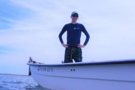 Michael Lonneman standing in a boat