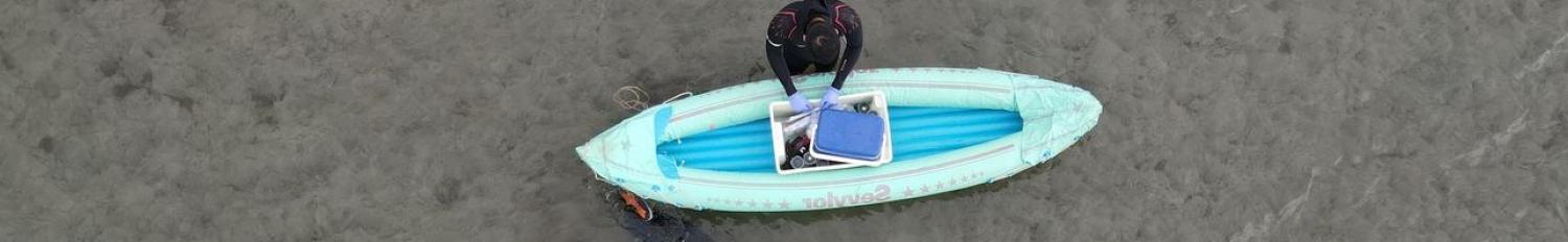Scientist working on float in sediment habitat