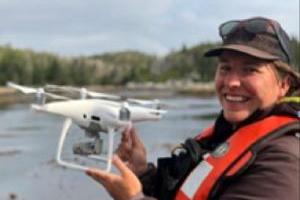 Luba Reshitnyk by the water with a drone
