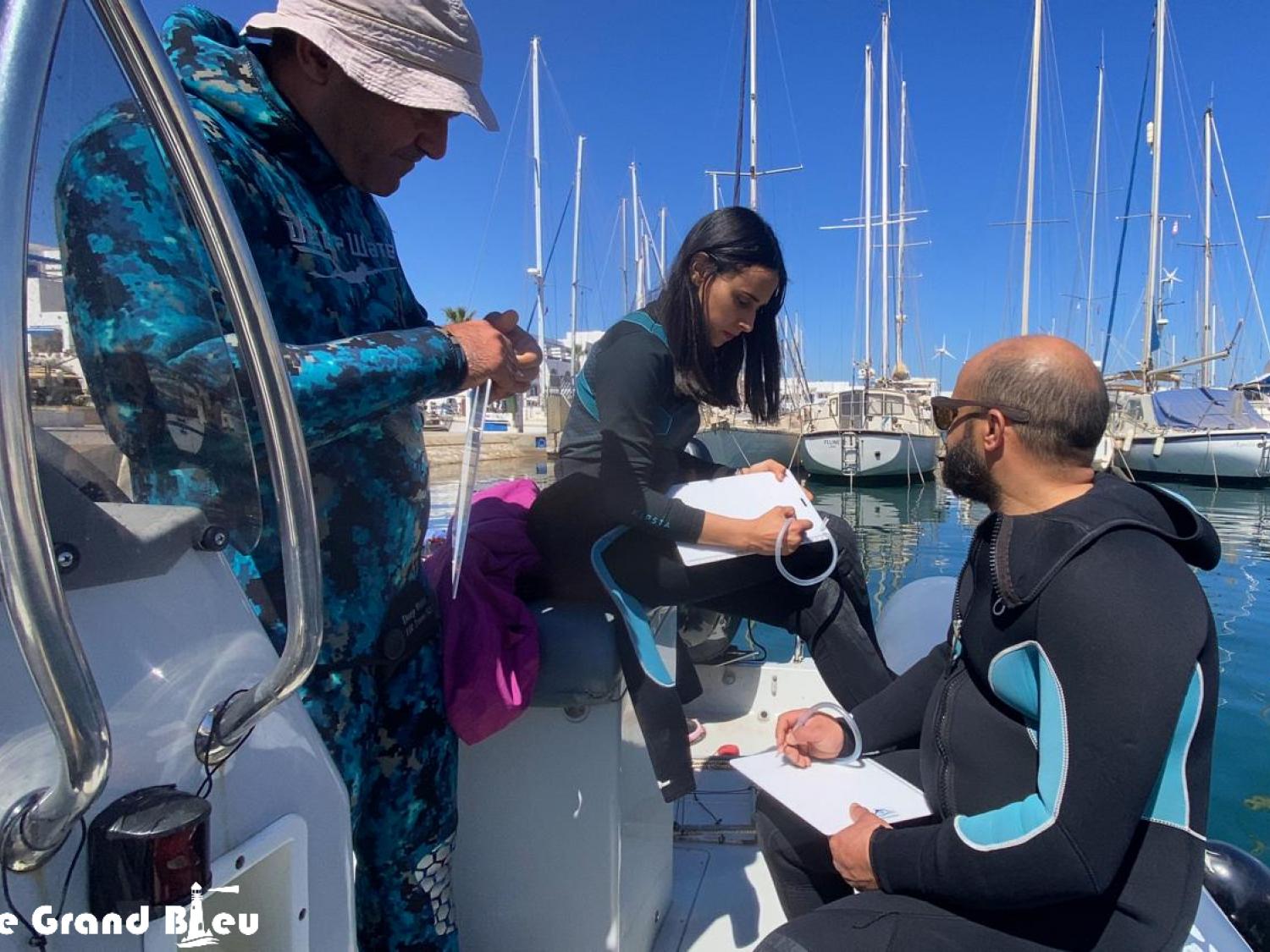 Ramla, Ahmed, and Mahdi conducting a briefing before heading out to dive for Posidonia restoration site monitoring